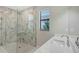 Modern bathroom features a glass enclosed shower with marble accents and a white single sink vanity at 4990 Fairhope Cir, Lakewood Ranch, FL 34211