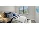 Cozy bedroom with neutral walls, large window, comfortable bed and modern decor creating a serene space at 4990 Fairhope Cir, Lakewood Ranch, FL 34211