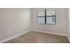 Bedroom with a large window and wood-look laminate flooring at 4990 Fairhope Cir, Lakewood Ranch, FL 34211