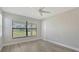 A bedroom features a large window and neutral decor for a serene retreat at 4990 Fairhope Cir, Lakewood Ranch, FL 34211