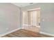 Living space with wood-look laminate flooring transitions to tile, leading to an adjacent room and doorway at 4990 Fairhope Cir, Lakewood Ranch, FL 34211