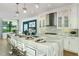 Spacious kitchen with island, white cabinets, stainless steel appliances, and quartz countertops at 4990 Fairhope Cir, Lakewood Ranch, FL 34211