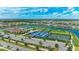 Community aerial view featuring a pool, tennis courts, a lake and lush landscaping at 4845 Carova Way, Lakewood Ranch, FL 34211