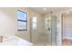 Modern bathroom with a glass shower, white vanity, and neutral tile at 4845 Carova Way, Lakewood Ranch, FL 34211