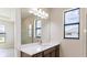 Bathroom with a vanity, large mirror, and neutral color palette at 4845 Carova Way, Lakewood Ranch, FL 34211