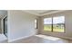 Well-lit bedroom featuring a large window and neutral decor at 4845 Carova Way, Lakewood Ranch, FL 34211
