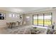 Spacious living room with large windows and seating area at 4845 Carova Way, Lakewood Ranch, FL 34211