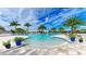 Beautiful resort-style community pool with palm trees and lounge chairs at 4845 Carova Way, Lakewood Ranch, FL 34211