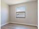 Bedroom with large window and wood-look flooring at 4845 Carova Way, Lakewood Ranch, FL 34211