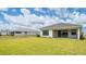 Large backyard with grassy area and home in background at 4845 Carova Way, Lakewood Ranch, FL 34211