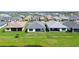 Aerial view of multiple homes with green lawns, landscaping, and community ponds at 4910 Carova Way, Lakewood Ranch, FL 34211