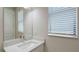 Bathroom vanity with a white countertop and square sink under a large mirror at 4910 Carova Way, Lakewood Ranch, FL 34211