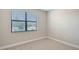 Bright bedroom featuring neutral paint, carpet, baseboards, and a window with blinds at 4910 Carova Way, Lakewood Ranch, FL 34211