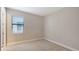 Well-lit bedroom with a window and blinds, complemented by neutral paint and carpet at 4910 Carova Way, Lakewood Ranch, FL 34211