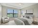 This bedroom is well-lit with a serene view, featuring a plush bed and modern decor at 4910 Carova Way, Lakewood Ranch, FL 34211