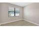 Neutral bedroom features light wood floors, a window, and neutral wall color at 4910 Carova Way, Lakewood Ranch, FL 34211