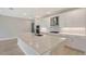 Modern kitchen features a large island, stainless steel appliances, and sleek white cabinetry at 4910 Carova Way, Lakewood Ranch, FL 34211