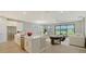 An open living area combines a modern kitchen with a spacious living room and dining area at 4910 Carova Way, Lakewood Ranch, FL 34211