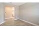 Living room features light wood flooring and an open view to the kitchen at 4910 Carova Way, Lakewood Ranch, FL 34211