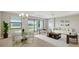 An open-concept living room with bright natural light, dining area, and modern furnishings at 4910 Carova Way, Lakewood Ranch, FL 34211