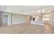 Large open-concept living space with kitchen, dining area, and living room under tray ceilings at 4910 Carova Way, Lakewood Ranch, FL 34211