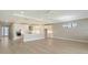 Spacious open-concept living area features modern kitchen and a spacious living area with light wood floors at 4910 Carova Way, Lakewood Ranch, FL 34211