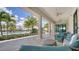 Outdoor patio area with comfortable seating overlooking the pool and palm trees at 4910 Carova Way, Lakewood Ranch, FL 34211