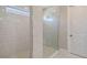 Walk-in shower with marble-style walls, modern fixtures, and a glass enclosure at 4910 Carova Way, Lakewood Ranch, FL 34211