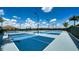 Blue and gray tennis courts with lighting and palm trees at 4910 Carova Way, Lakewood Ranch, FL 34211