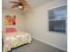 Charming bedroom with floral bedding and ceiling fan at 7280 Verna Bethany Rd, Myakka City, FL 34251