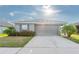 Front view of a single-story house with gray siding and a two-car garage at 6609 Bayston Hill Pl, Zephyrhills, FL 33541