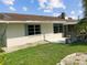 House exterior with a backyard patio and lawn at 716 Fox Hills Dr, Sun City Center, FL 33573