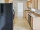Eat-in kitchen with light wood cabinets and stainless steel appliances at 716 Fox Hills Dr, Sun City Center, FL 33573