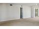 Spacious living room with carpet, access to other rooms, and lots of natural light at 716 Fox Hills Dr, Sun City Center, FL 33573