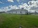 Rear view of a home showcasing a large backyard at 13817 Carryback Dr, Dade City, FL 33525