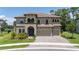 Two-story home with three-car garage and landscaping at 291 Mossy River Ct, Brandon, FL 33511