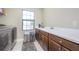 Laundry room with dark brown cabinets, a sink and a window at 291 Mossy River Ct, Brandon, FL 33511