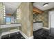 Vanity area with unique wallpaper and black marble floors at 200 Colony Point S Rd, St Petersburg, FL 33705