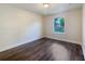 Simple bedroom with wood-look flooring and a window with blinds at 5015 17Th St, Zephyrhills, FL 33542