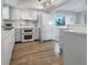 Updated kitchen featuring white appliances and tile flooring at 2413 Riverbluff Pkwy # V-231, Sarasota, FL 34231