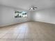 Spacious living room with tile floors and large window at 2413 Riverbluff Pkwy # V-231, Sarasota, FL 34231