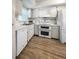 Kitchen with white cabinets, double oven, and tile floor at 2413 Riverbluff Pkwy # V-231, Sarasota, FL 34231