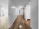 Bright hallway with wood-look flooring leading to bedrooms and bath at 2413 Riverbluff Pkwy # V-231, Sarasota, FL 34231