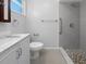 Bathroom with walk-in shower, grab bar, and marble countertop at 2413 Riverbluff Pkwy # V-231, Sarasota, FL 34231