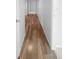 Long hallway with wood-look tile flooring at 2413 Riverbluff Pkwy # V-231, Sarasota, FL 34231