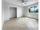 Spacious bedroom featuring tile flooring and a large closet at 2413 Riverbluff Pkwy # V-231, Sarasota, FL 34231