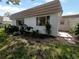 White exterior with brown roof, lush landscaping, and a paved walkway at 2413 Riverbluff Pkwy # V-231, Sarasota, FL 34231