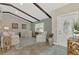 Living room features exposed wood beams, light walls, and neutral furniture at 3228 Hercules Rd, Venice, FL 34293