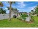 Landscaped backyard with a white fence and lush green grass at 3228 Hercules Rd, Venice, FL 34293