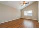 Spacious bedroom with wood-look floors and ceiling fan at 3720 Orangepointe Rd, Valrico, FL 33596